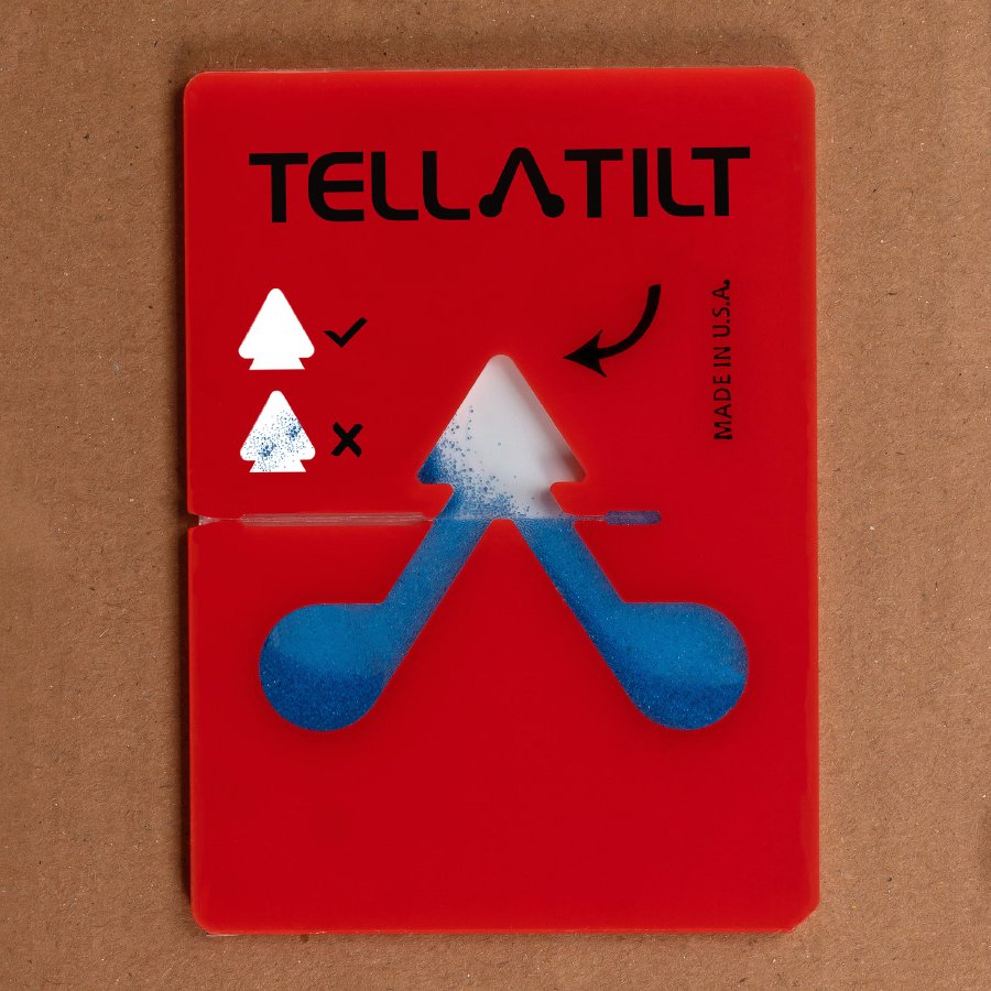 Paket mit Kippindikator wird zurck geneigt - Kgelchen bleiben im Klebebereich haften